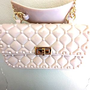 Jelly Bag- quilted crossbody purse in blush with gold crossbody chain.